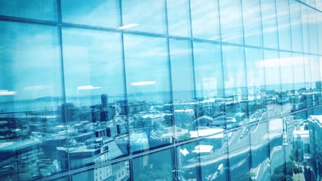 Cityscape-reflected-in-modern-building-windows-with-blue-sky