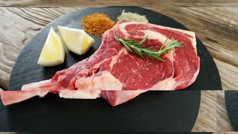Raw-steak-chop-and-ingredients-on-black-board