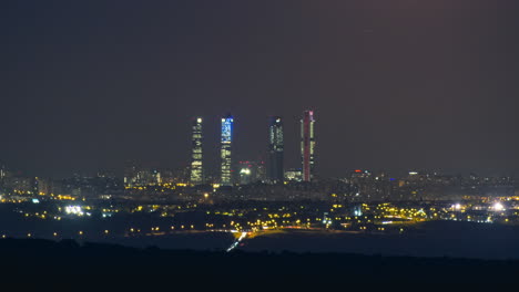 Moon-rising-over-the-Cuatro-Torres-in-Madrid,-Spain