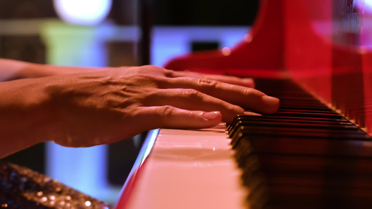 Close-up of an elderly woman playing a red piano