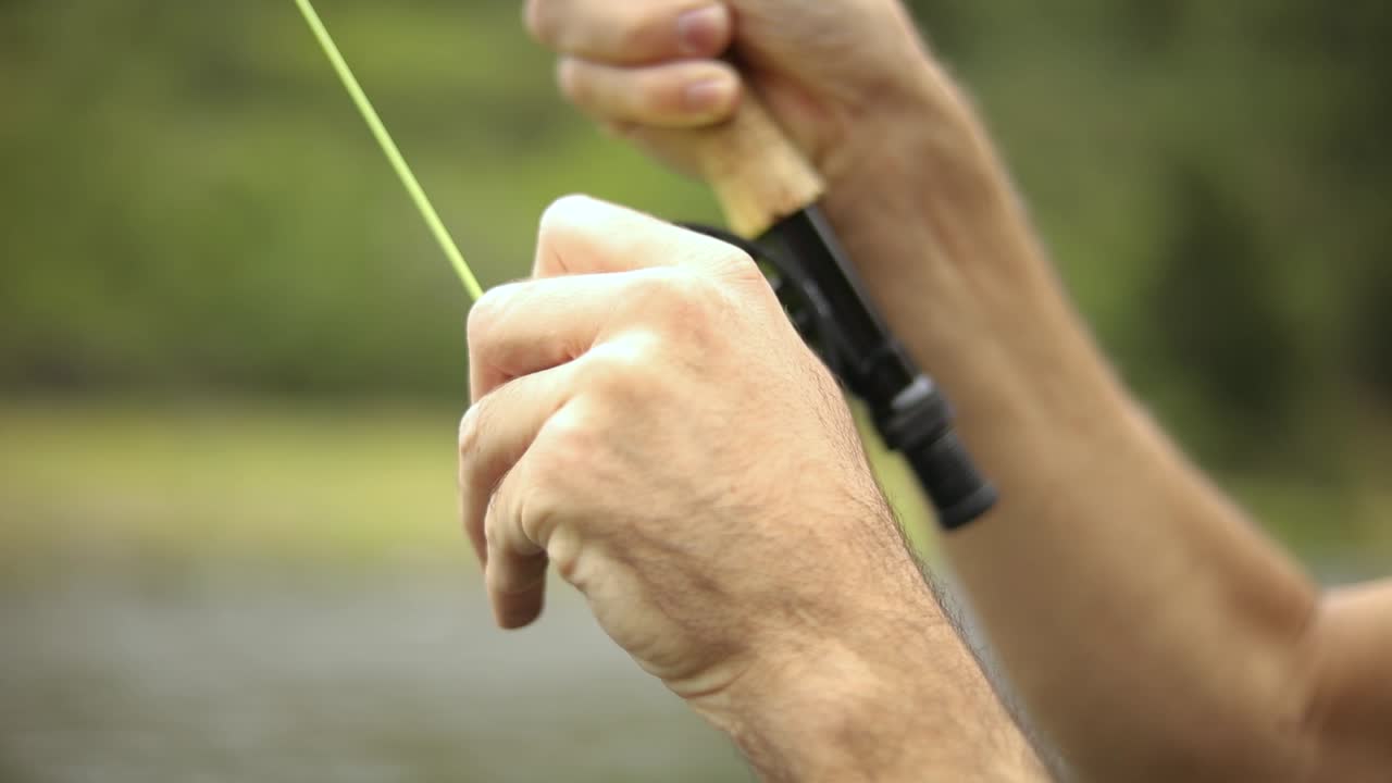 Shot of a male fisherman wearing waders while Fly Fishing-1