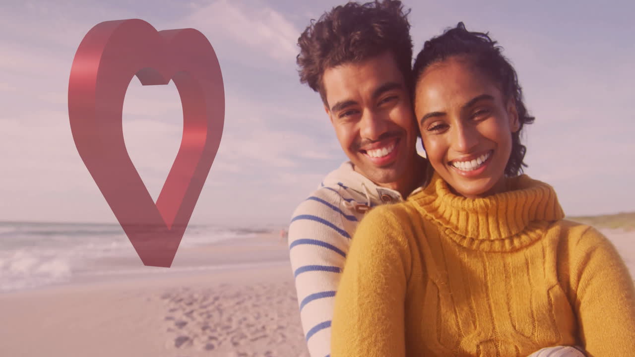 Smiling couple embracing on beach with heart-shaped animation beside them