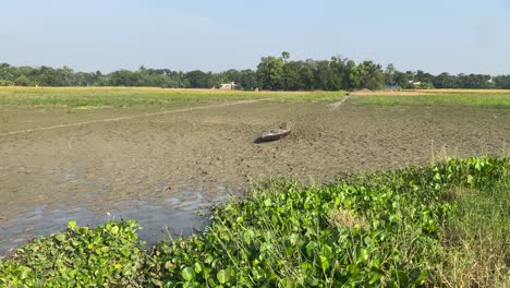 old vintage wooden boat in farmland at bortirbil,west bengal after flood