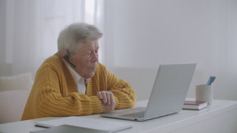 old woman talk with her granddaughter on video call using a laptop.video conference with a doctor