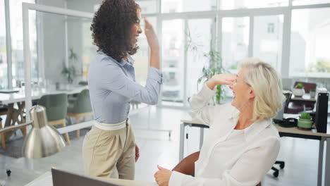 two women celebrating success in the office