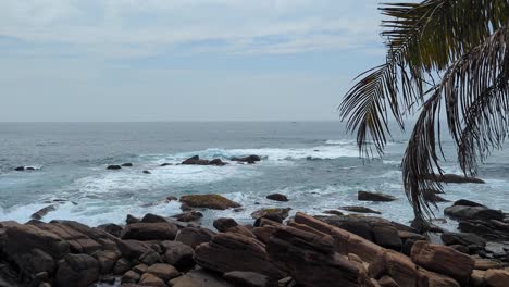 scenic coastal view of waves breaking over rocky outcrop and shoreline on south coast sri lanka