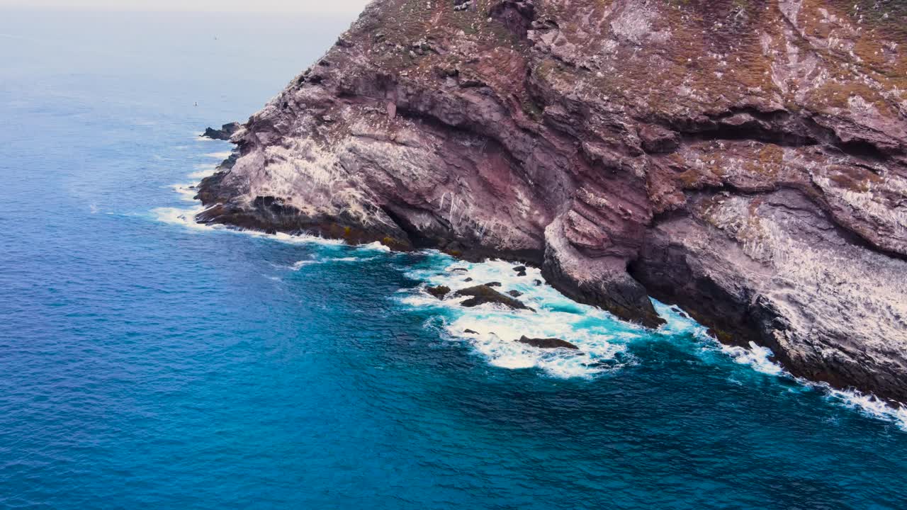 Aerial View of Dramatic Rocky Coastline and Ocean Waves