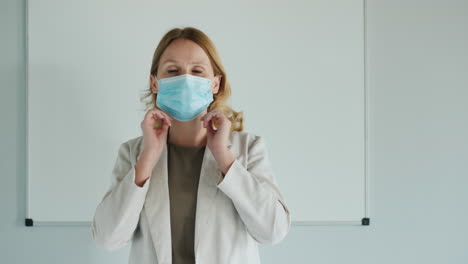 Teacher-Wears-Protective-Mask-In-Front-Of-Classroom