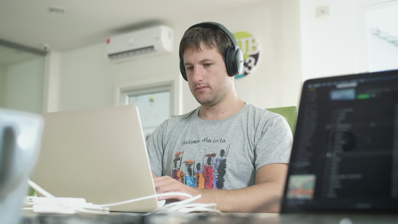 Software Developer Coding on Laptop in Digital Nomad Co Working Space. Travel, Freedom and Remote Work Career Concept.