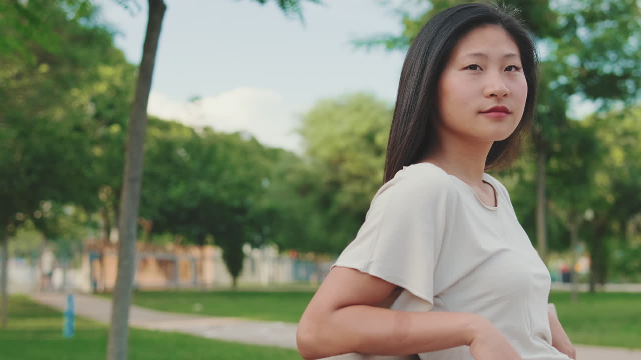 Portrait of an Asian woman in a park