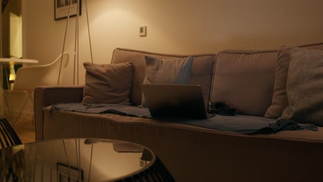 laptop on a couch at night