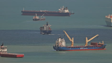 singapore - 5 march 2025 : container ships waiting in the sea by singapore