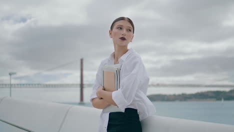 businesswoman waiting meeting street with folder paper. manager break vertically