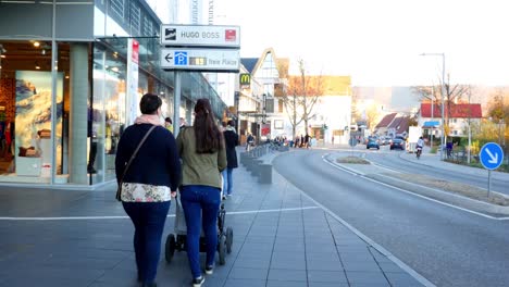 city street scene with pedestrians and shops