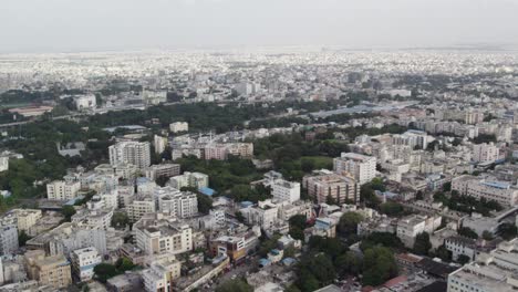 aerial footage shows crowded mid-size apartments and railway station train leaving in a city in india, the commercial area around star hotels, and one of the city's wealthiest neighbourhoods