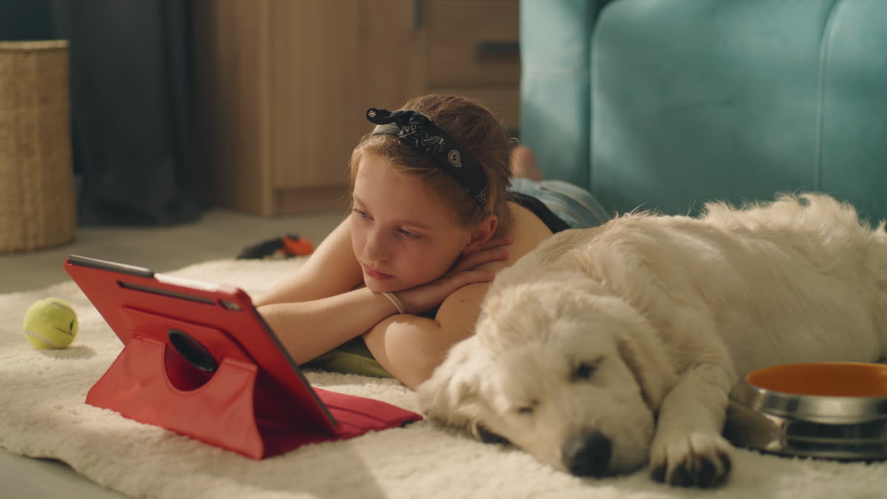 Girl and Dog Relaxing with Tablet