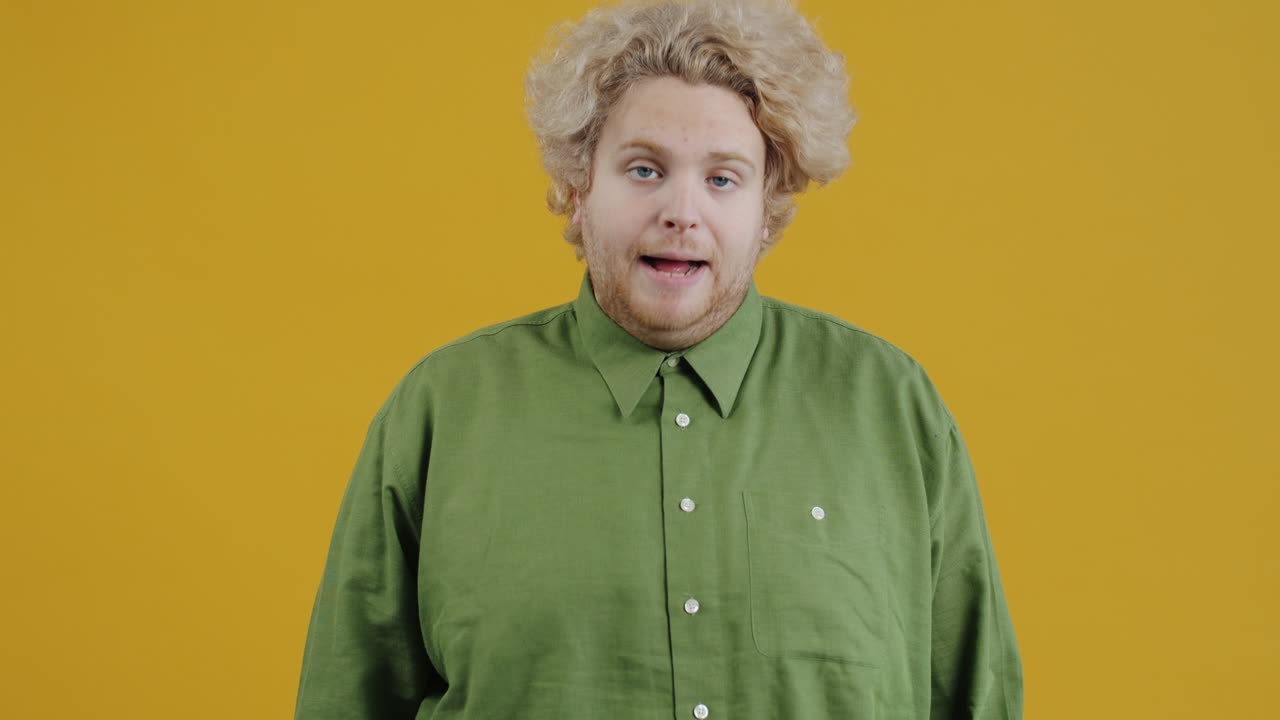 Man with Curly Hair in a Green Shirt