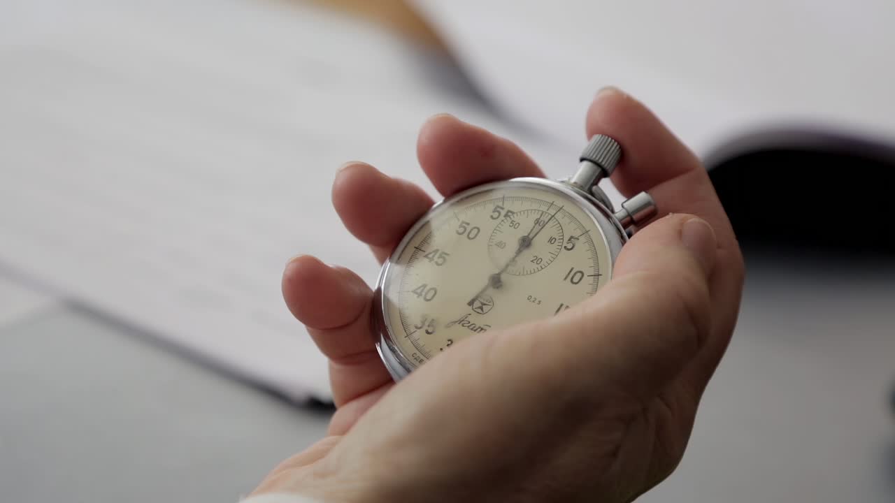 Closeup of a stopwatch in his hand