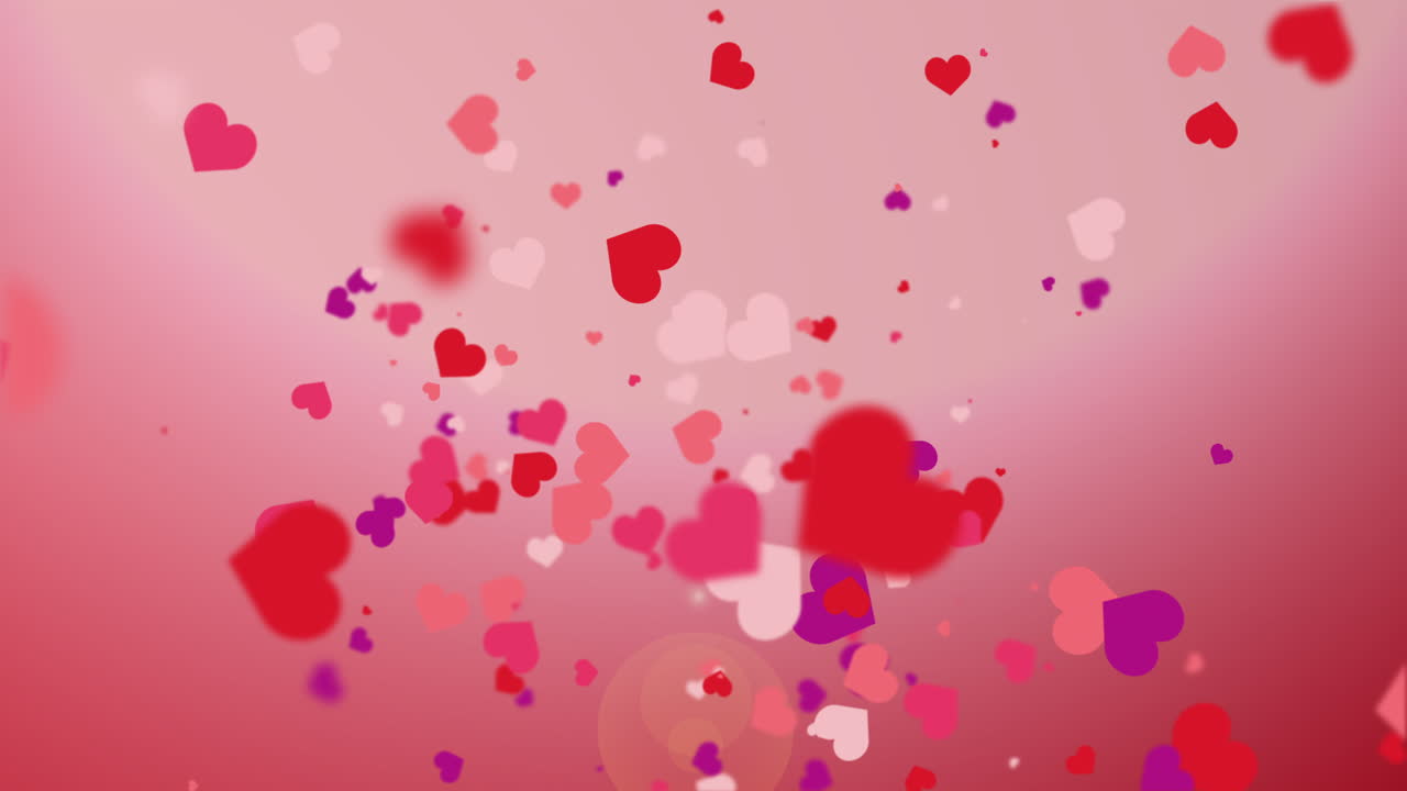Freely falling down colored figures of hearts. Animated abstract pink background. Looped video. Concept for valentine's day, wedding.