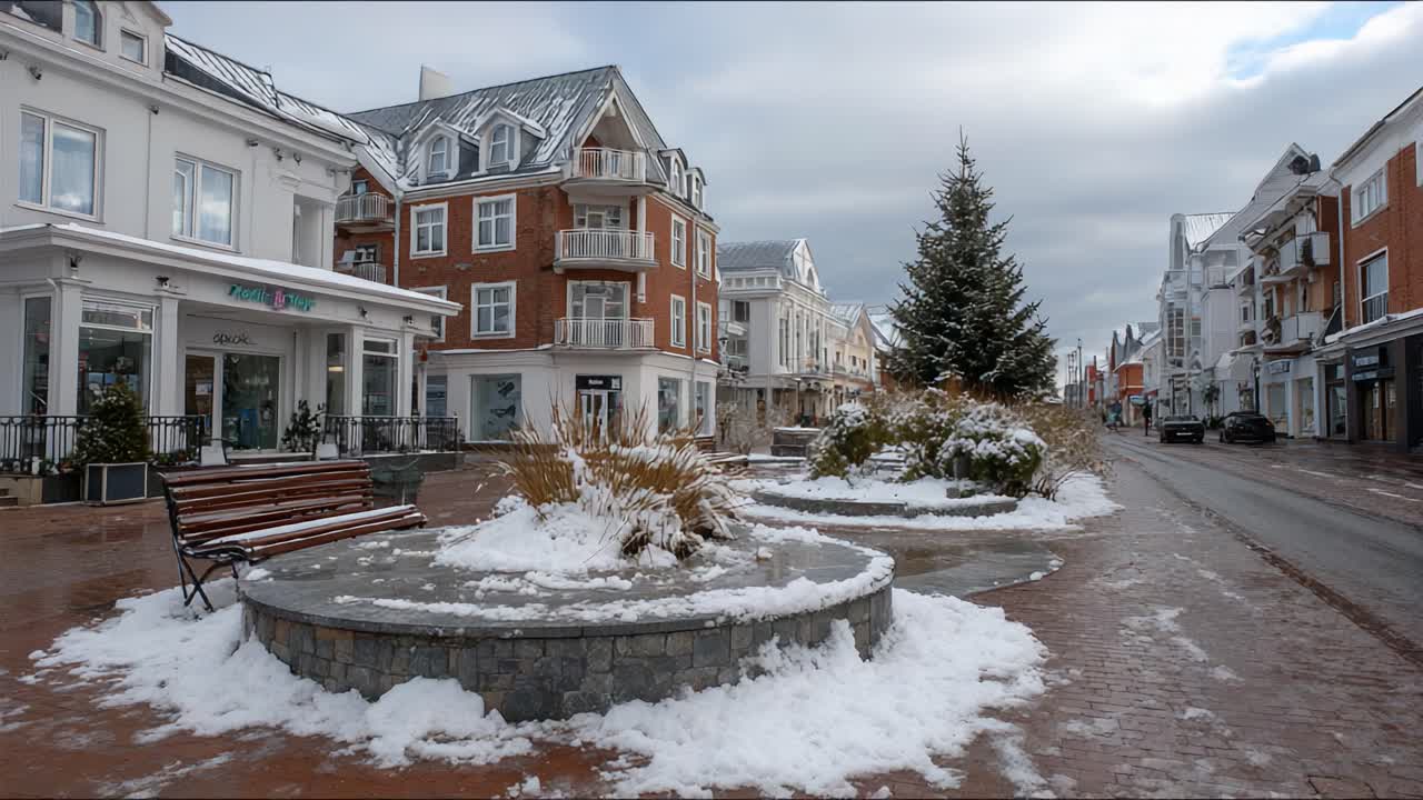 Winter Scene in a Charming Town Square Featuring Snow-Covered Landscaping, Modern Architecture, and a Christmas Tree Amidst a Serene Urban Atmosphere