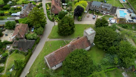 an arc shot of st margaret of antioch church and surrounding village houses