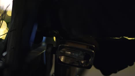 person unlocking bike in the city at night