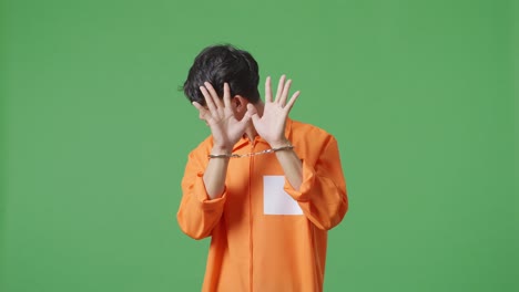 man in orange jumpsuit and handcuffs