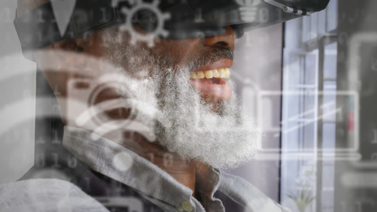 múltiples iconos digitales contra afroamericano hombre de negocios de alto nivel que lleva auriculares vr en la oficina