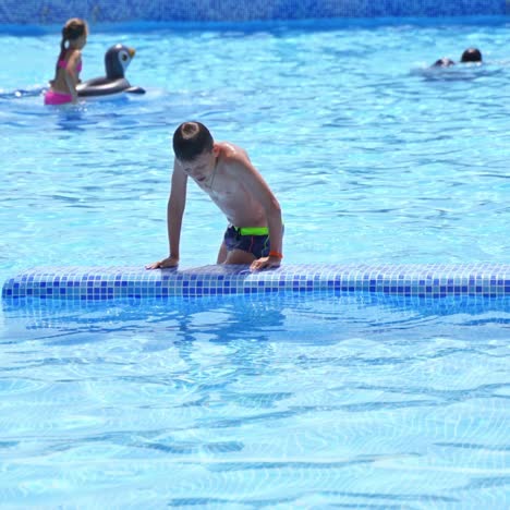 boy playing in pool