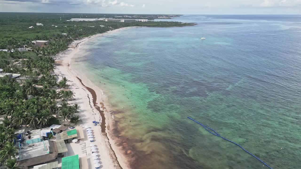 Aerial view of Xpu-ha beach with calm waves, sunny day, relaxed vibe