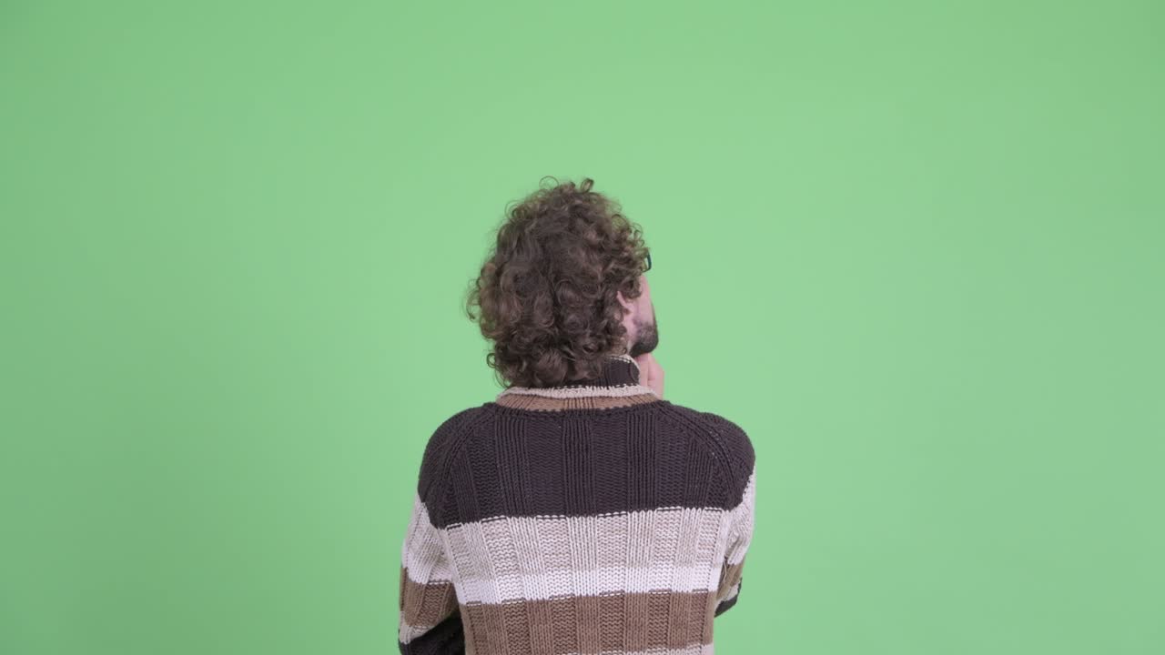 Young handsome bearded man with curly hair
