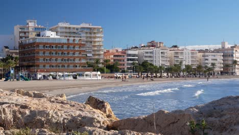 beachfront buildings and people on sandy beach
