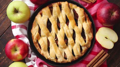 homemade pastry apple pie with bakery products on dark wooden kitchen table