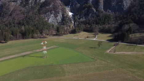 Aerial-circling-of-Power-lines-and-tower-in-alpine-environment