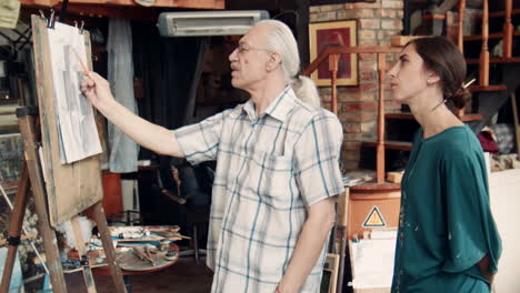 art class:  teacher guiding student in drawing