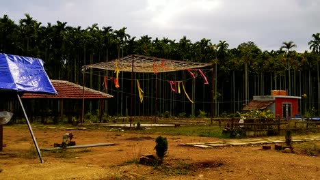 colorful flags hanging from a building structure blow in a breeze