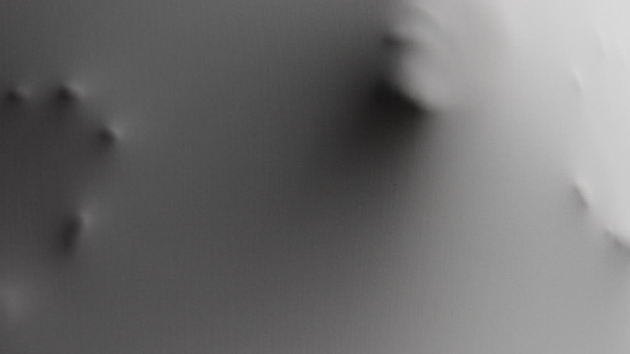 A creepy silhouette of a woman's face appears screaming from the white surface