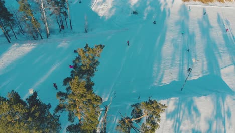 people go skiing and ride snowboards at winter resort aerial