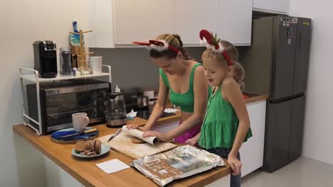 mother and daughter baking christmas cookies