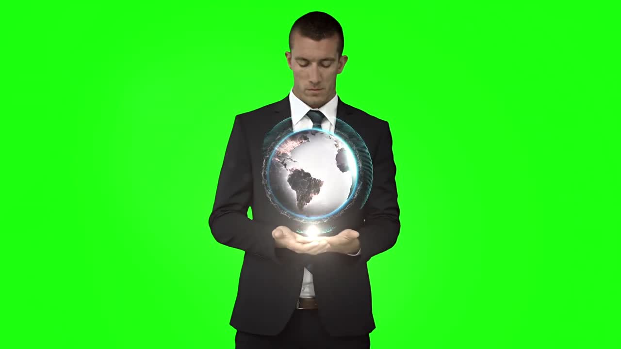녹색 스크린 앞에 글로브 애니메이션을 가진 사업가