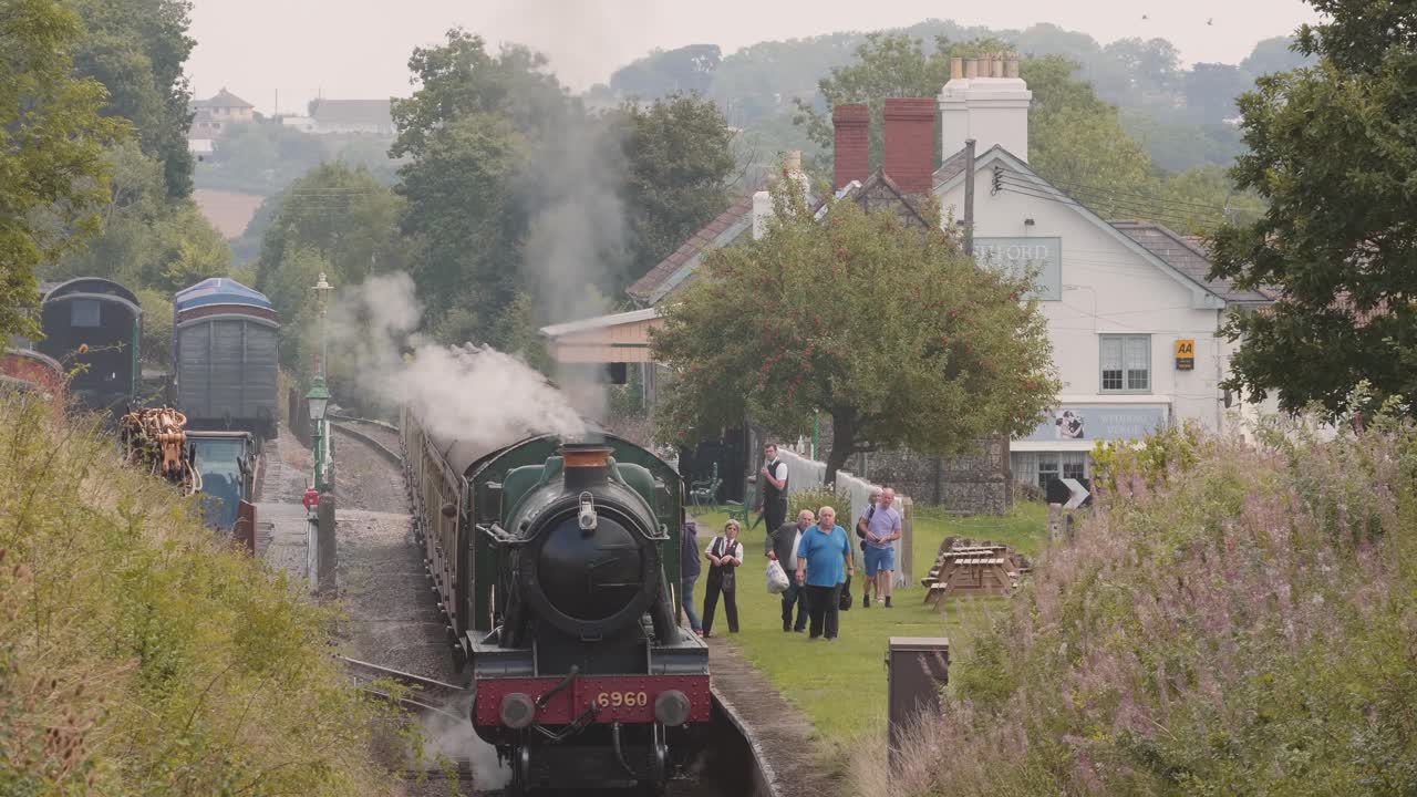 Tourists getting off a steam train on a heritage railway in Washford, England