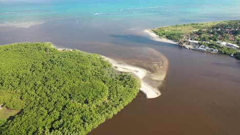 drone view of the river santo antônio flowing into the beach of the same name