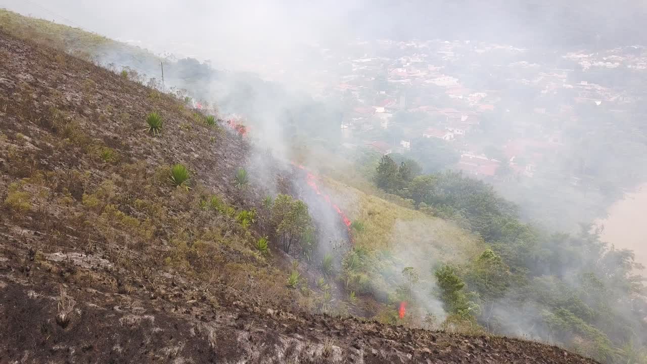 un avión volando hacia atrás cerca de mountain fire, brasil