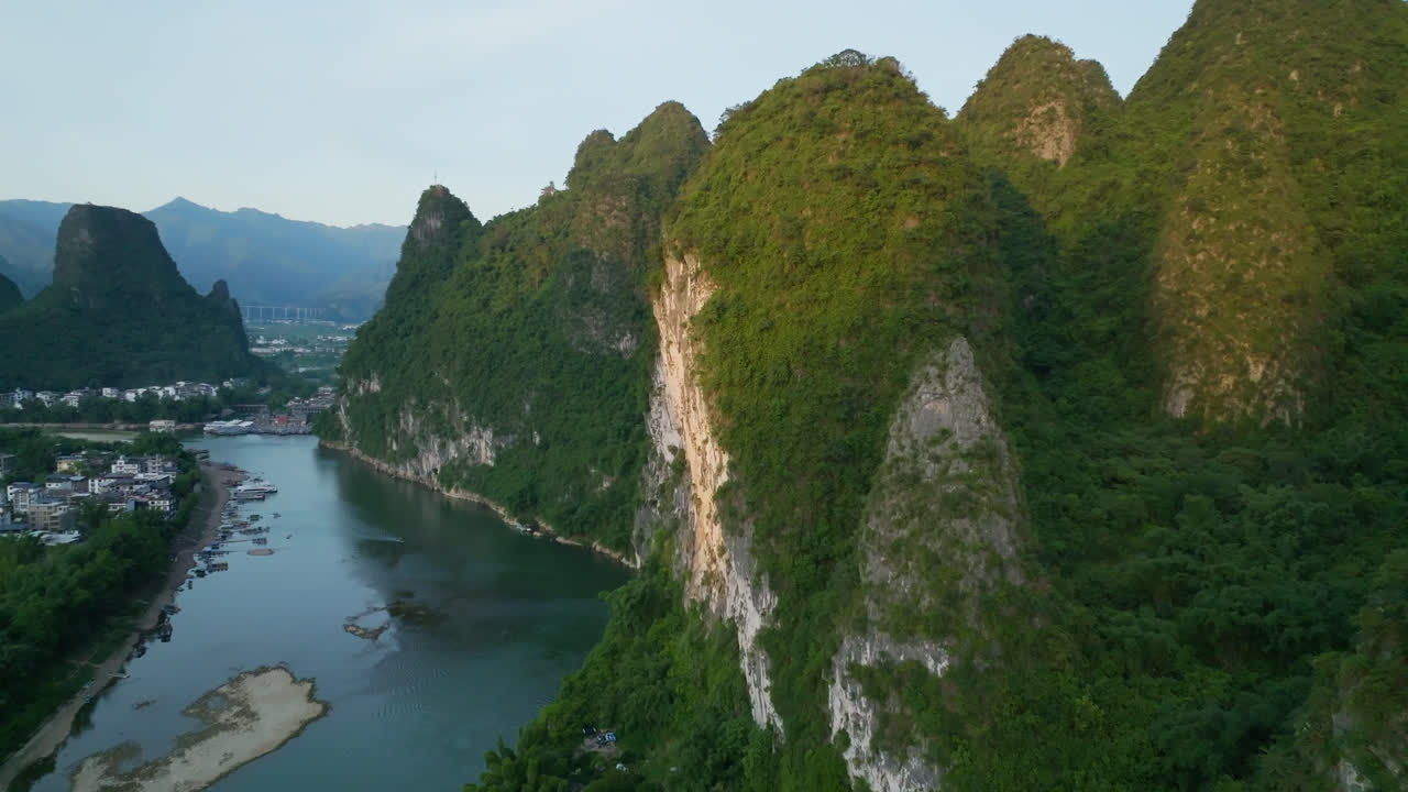 Aerial view close to a mountain wall, toward Xingping town, sunset in China