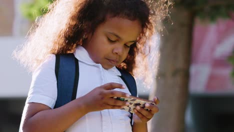 young girl using smartphone outdoors
