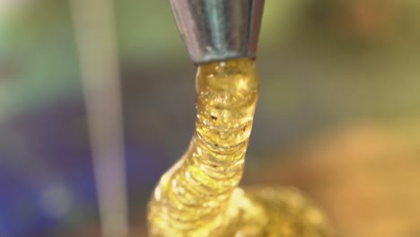 micro bubbles in high detail macro golden hot glue dripping out macro close up
