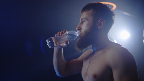 athlete drinking water after workout
