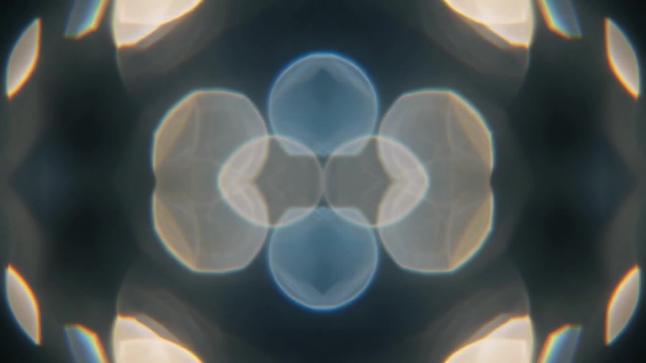 Abstraktní kaleidoskopický vzor zářícího světelného bokehu