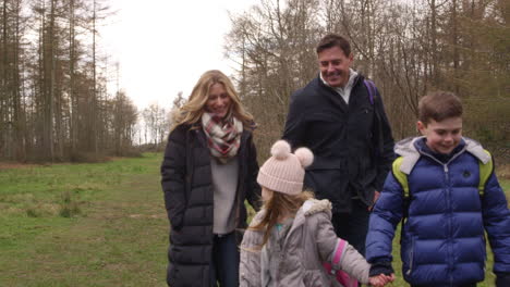 family walking in woods towards tracking handheld camera, shot on r3d