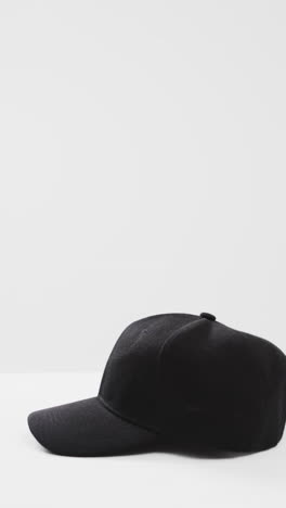 vertical video of black baseball cap and copy space on white background
